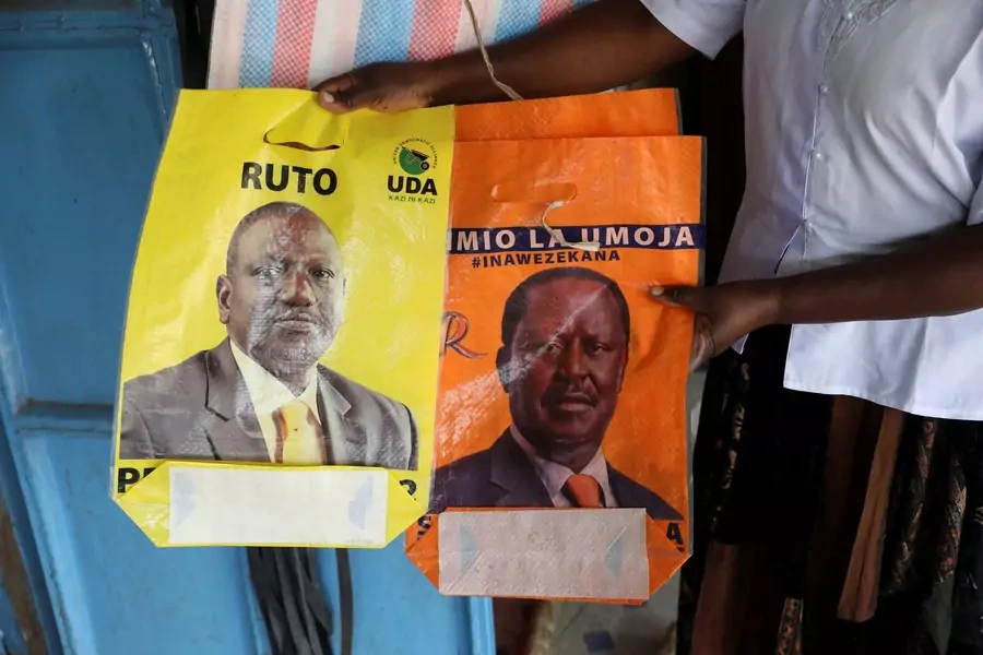 A shop owner hold bags depicting presidential candidates Raila Odinga and William Ruto, in the town of Kibigori, Kisumu county, Kenya, July 30, 2022.