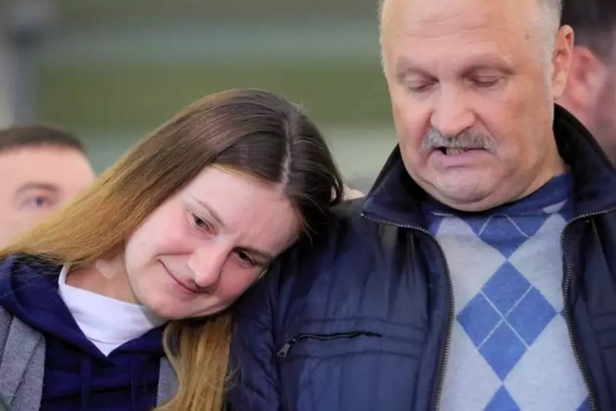 Convicted Russian agent Maria Butina leans on the shoulder of her father, Valery Butin, at Sheremetyevo International Airport after Butina's release from U.S. custody
