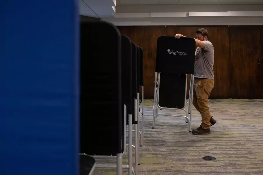 City employees set up voting booths the day before primary elections in Birmingham, Michigan