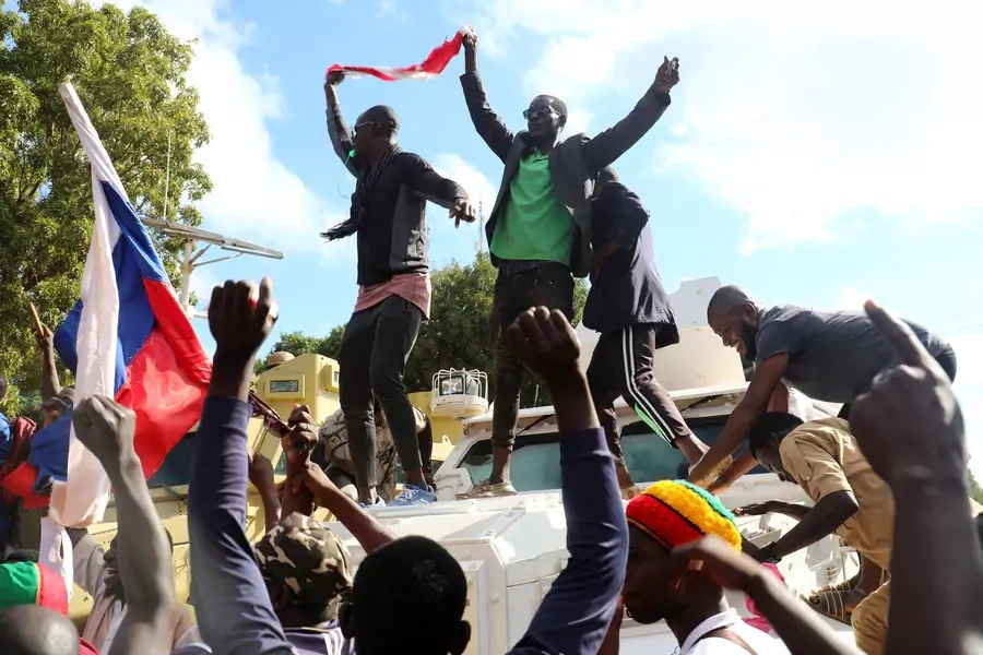 Supporters of Burkina Faso's self-declared new leader Ibrahim Traore demonstrate holding a Burkina Faso and Russian flags in Ouagadougou, Burkina Faso on October 2, 2022.