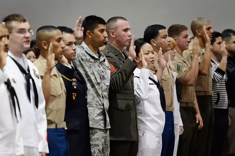 Several members of U.S. armed forces take the oath of citizenship at a naturalization ceremony at the Los Angeles Convention Center on June 27, 2012 in Los Angeles, California.