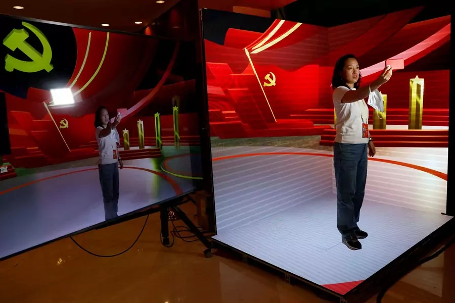 A woman poses for pictures at a digital media demonstration zone inside a media hotel for journalists covering the 20th National Congress of the Communist Party of China, in Beijing, China, October 19, 2022.