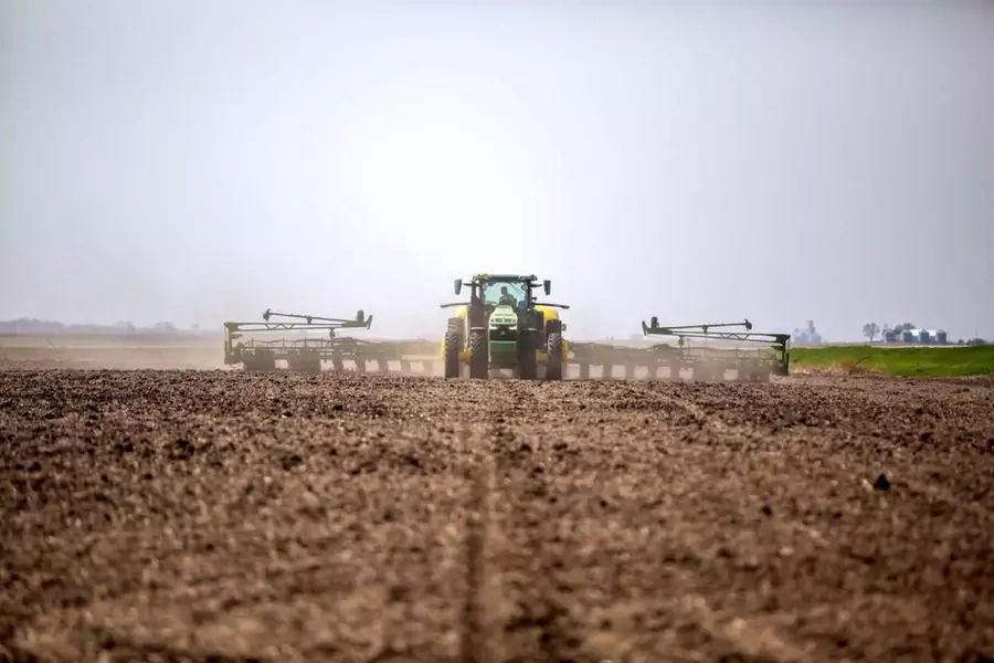A farmer drives a tractor in Iowa in April 2021.