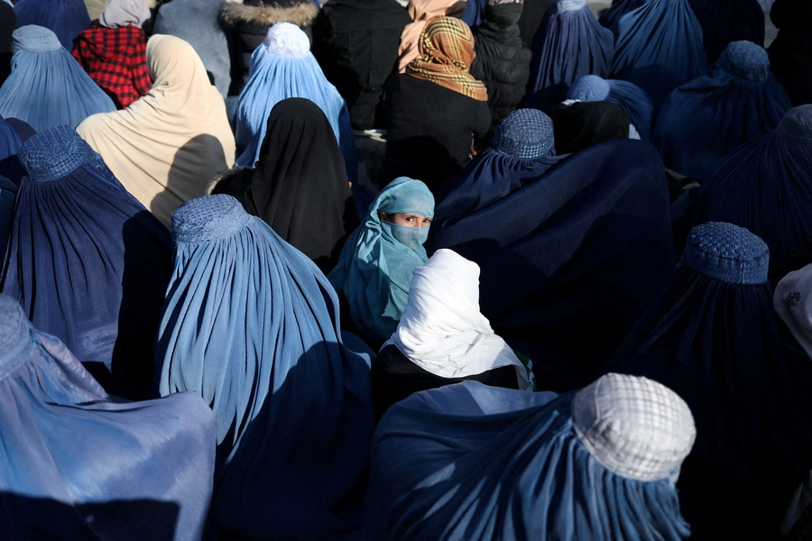 People wait to receive bread in Kabul.