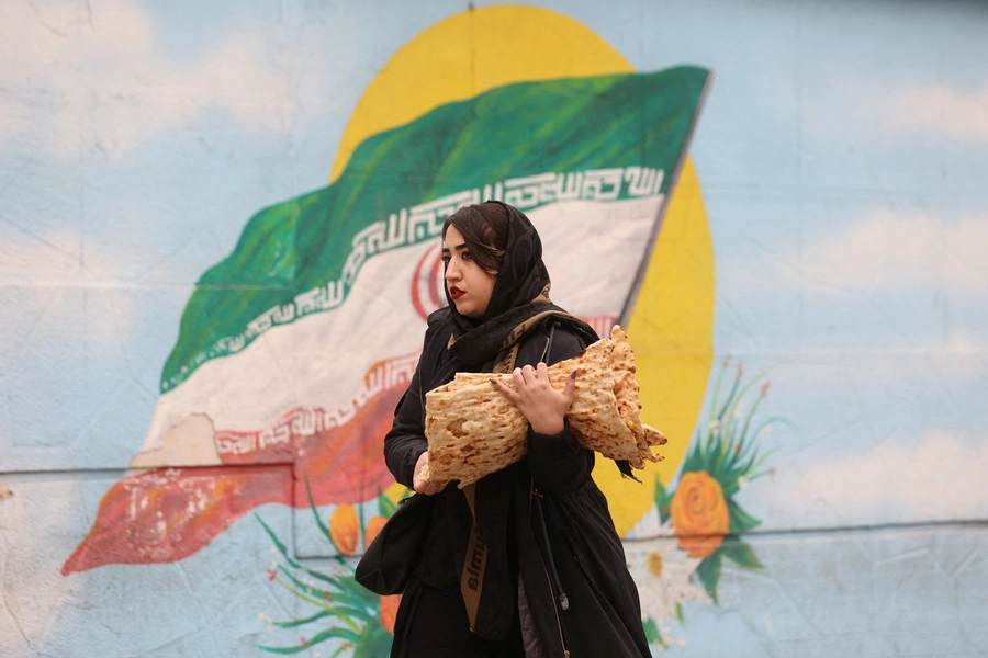 Women walk after morality police shut down in Tehran.