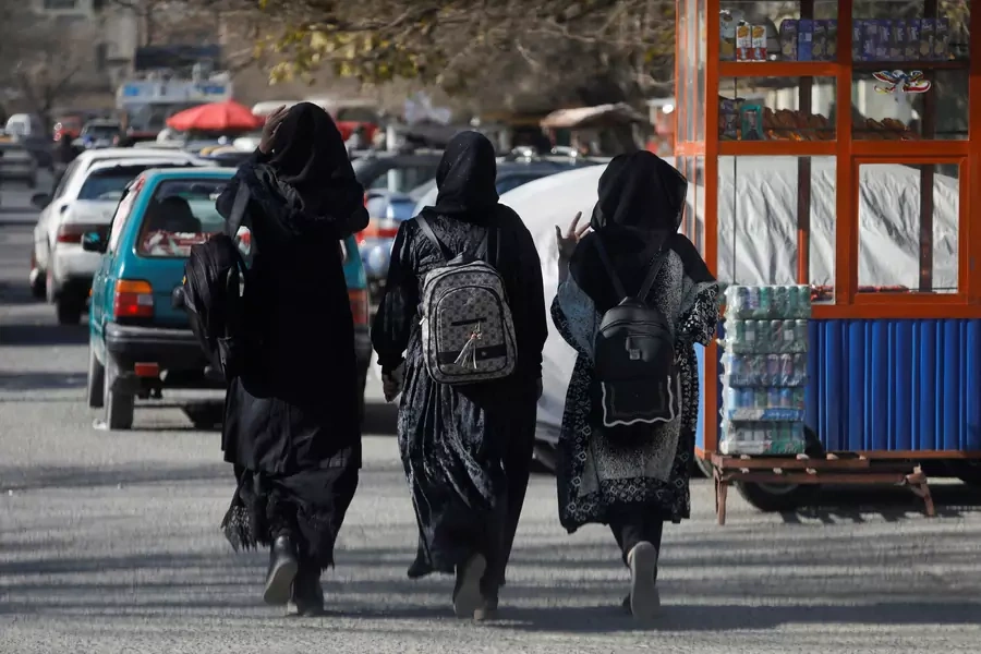 Afghan female students walk near Kabul University in Kabul.