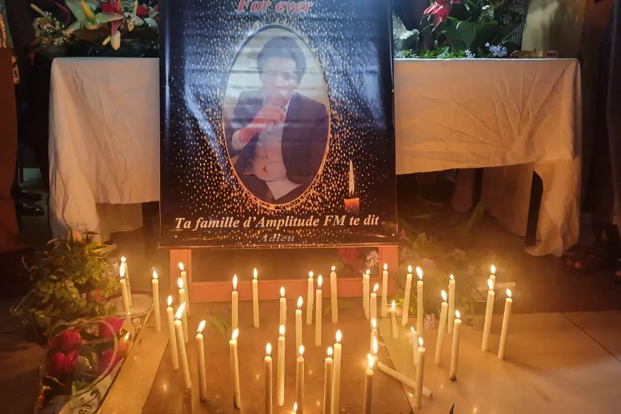 Candles are kept in front of Cameroon journalist Martinez Zogo's photo as fellow journalists pay their last respect to him after he was found dead after abduction, in Yaounde, Cameroon on January 23, 2023.