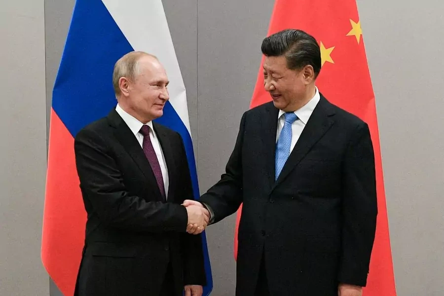 Russian President Vladimir Putin and Chinese President Xi Jinping shake hands after meeting on the sidelines of a summit in Brasilia in November 2019.