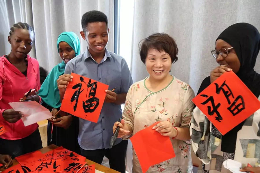 Students display their calligraphy works during an event greeting the Chinese Lunar New Year at the Confucius Institute of University of Dar es Salaam in Tanzania on January 11, 2023.