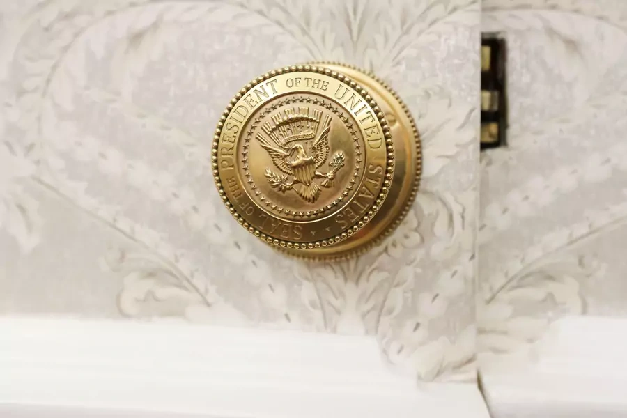 The official seal of the President of the United States on a doorknob in the Oval Office.