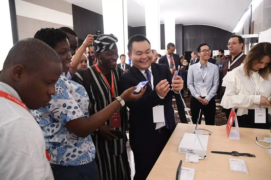A staff member of Huawei introduces the latest technology of Huawei products to visitors from Benin at a forum of Northern Africa Innovation Day in Tunis, Tunisia, on September 23, 2019.