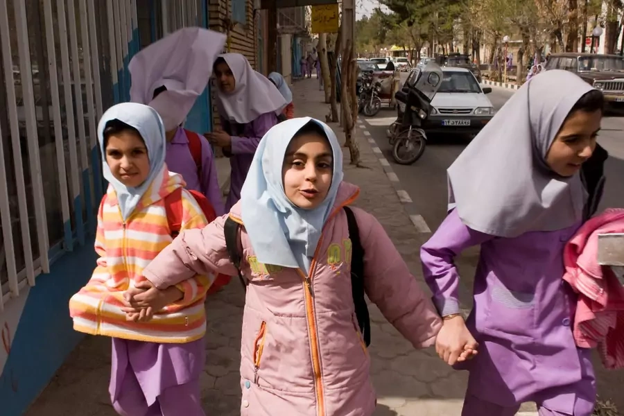 School girls walk down the street in Iranian President Mahmoud Ahmadinejad's birth village of Aradan.
