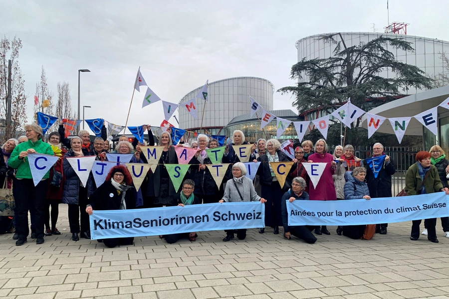 A group from the Senior Women for Climate Protection association hold banners outside the European Court of Human Rights in Strasbourg.