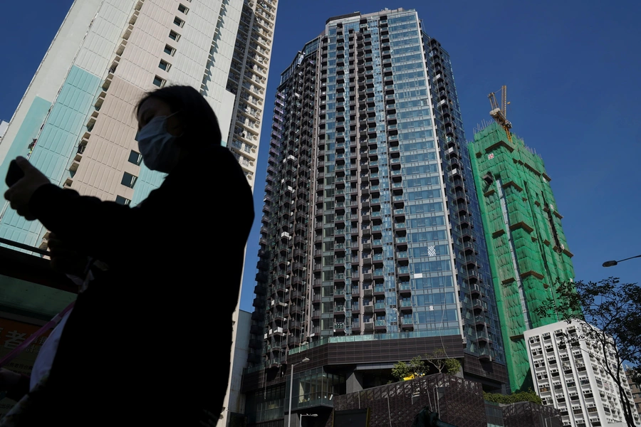 A pedestrian walks past an Evergrande residential development in Hong Kong, China, November 27, 2021. (Lam Yik/REUTERS)