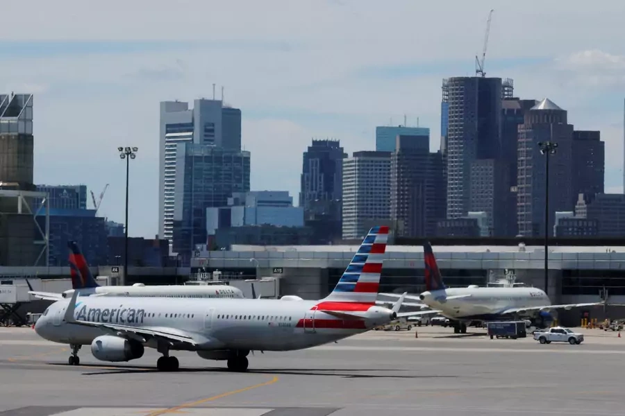 An American Airlines plane taxis in front of the skyline at Logan Airport before the July 4th holiday weekend in Boston, Massachusetts.