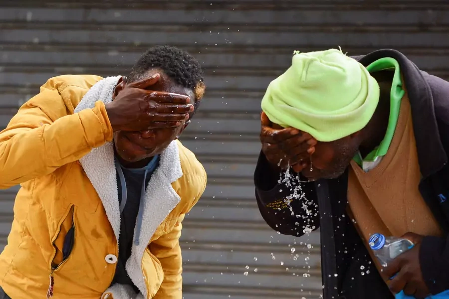 Demonstrators wash their face from teargas after clashing with riot police as they participate in a nationwide protest over cost of living and President William Ruto's government in downtown Nairobi, Kenya on March 20, 2023.