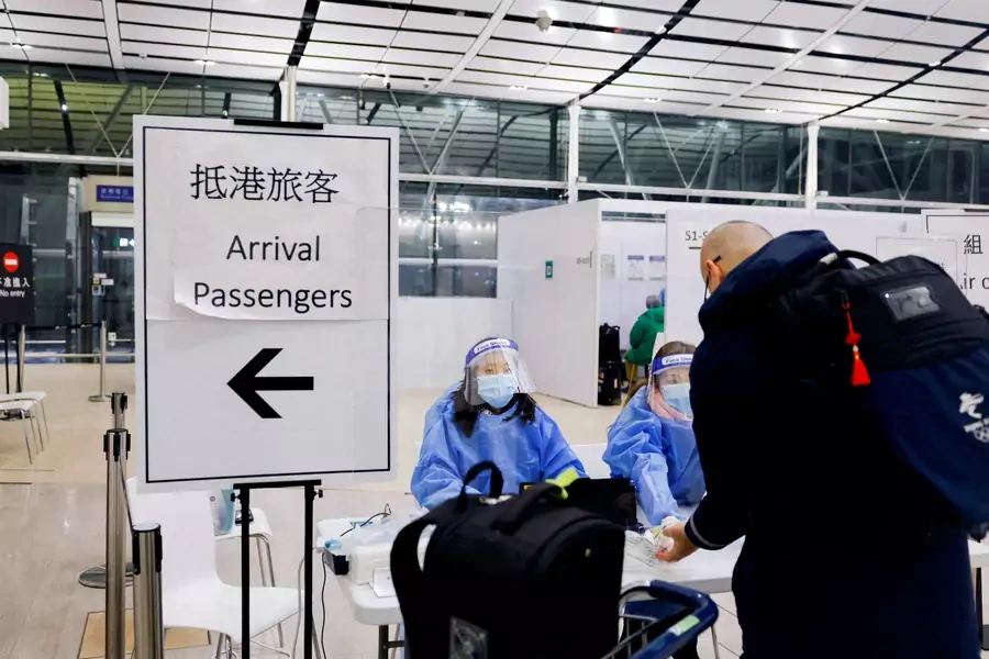 A traveller waits for PCR test to prevent the spread of the coronavirus disease (COVID-19), as he arrives at the Hong Kong International Airport, in Hong Kong, China February 21, 2022. (Tyrone Siu/Reuters)