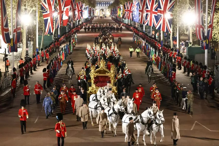 The Gold State Coach is ridden alongside members of the military during a full overnight dress rehearsal of the coronation ceremony of Britain’s King Charles III.