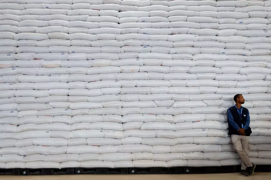 A worker stands by bags of wheat during an official visit to the World Food Program (WFP) warehouse in Adama, Ethiopia on January 12, 2023.