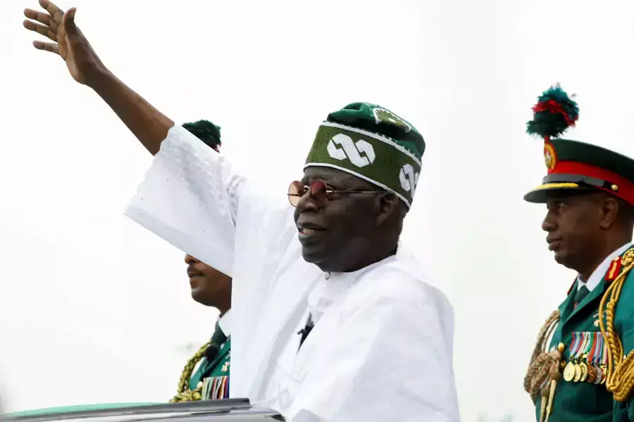Nigeria's President Bola Tinubu waves to a crowd as he takes the traditional ride on top of a ceremonial vehicle, after his swearing-in ceremony in Abuja, Nigeria on May 29, 2023. 
