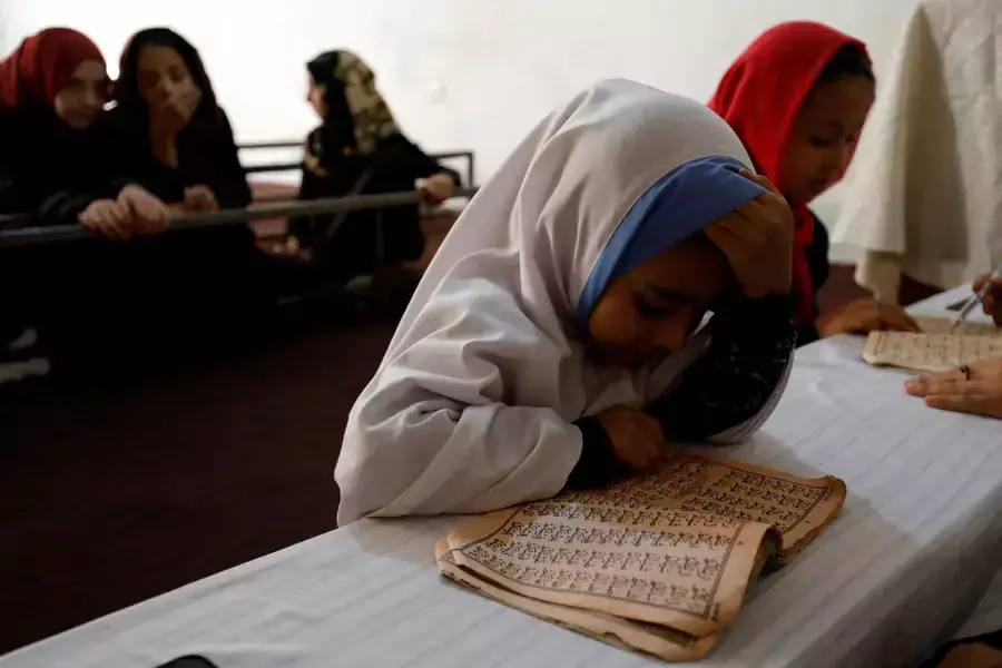 An Afghan girl reads the Koran in a madrasa or religious school in Kabul, Afghanistan, October 8, 2022.