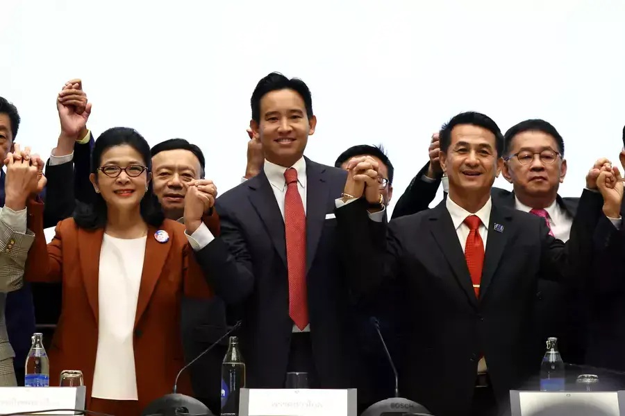 Move Forward Party leader Pita Limjaroenrat holds hands with coalition party leaders following a meeting with coalition partners in Bangkok, Thailand, on May 18, 2023.