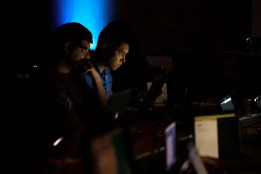 Andrew Beard and Barrett Darnell compete in a contest during the Def Con hacker convention in Las Vegas, Nevada on July 29, 2017