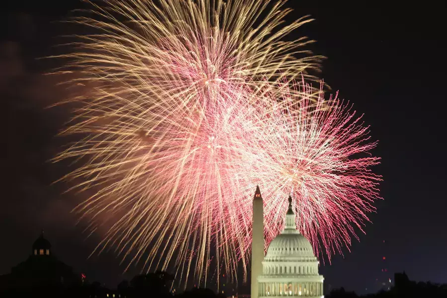 Fireworks explode behind the U.S. Capitol and Washington monument on Independence Day.