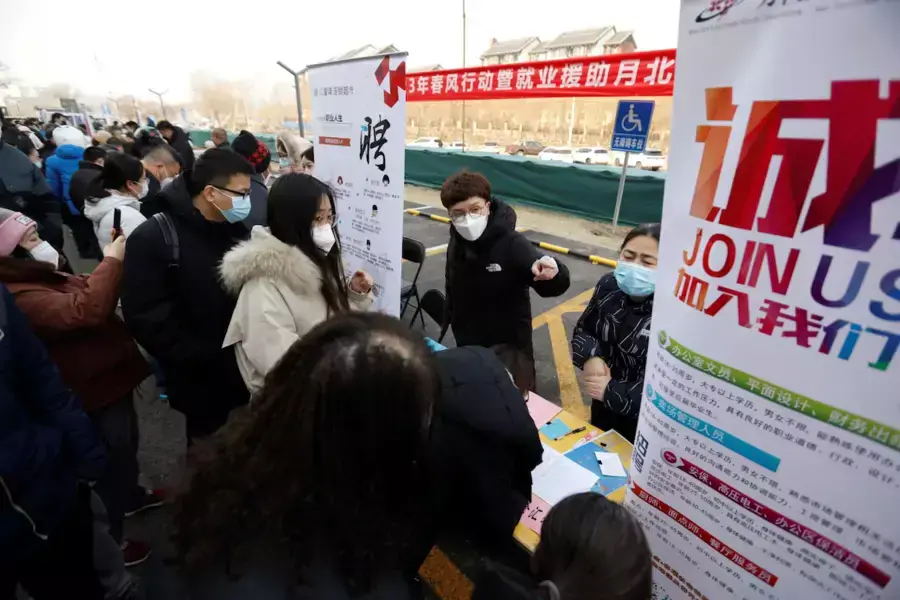 Job seekers crowd around a booth at a job fair in Beijing, China.