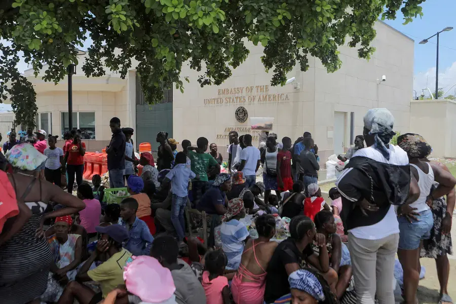 People escaping the threat of armed gangs rest under a tree as they camp in front of the U.S. Embassy, in Port-au-Prince, Haiti, July 25, 2023.