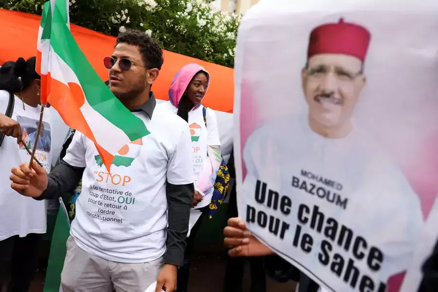 A demonstrator holds Niger's flag outside Niger's embassy in support of the President of Niger Mohamed Bazoum in Paris, France on August 5, 2023