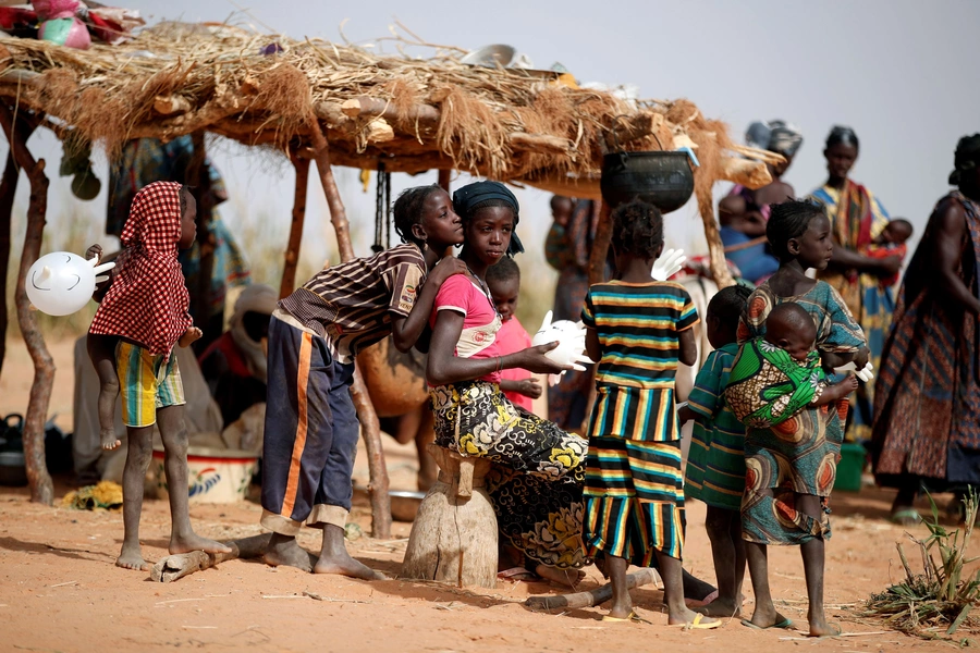 Women and children are pictured during an assistance operation to nomade families during the regional anti-insurgent Operation Barkhane in Tin Hama.