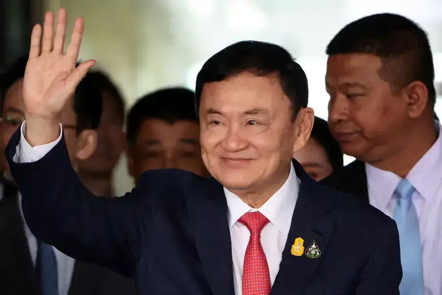 Former Thai Prime Minister Thaksin Shinawatra, who is expected to be arrested upon his return as he ends almost two decades of self-imposed exile, waves at Don Mueang airport in Bangkok, Thailand, on August 22, 2023.