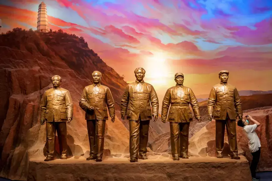 A man takes pictures next to statues of former Chinese communist leaders at the Museum of the Communist Party of China in Beijing, China, on June 25, 2021.