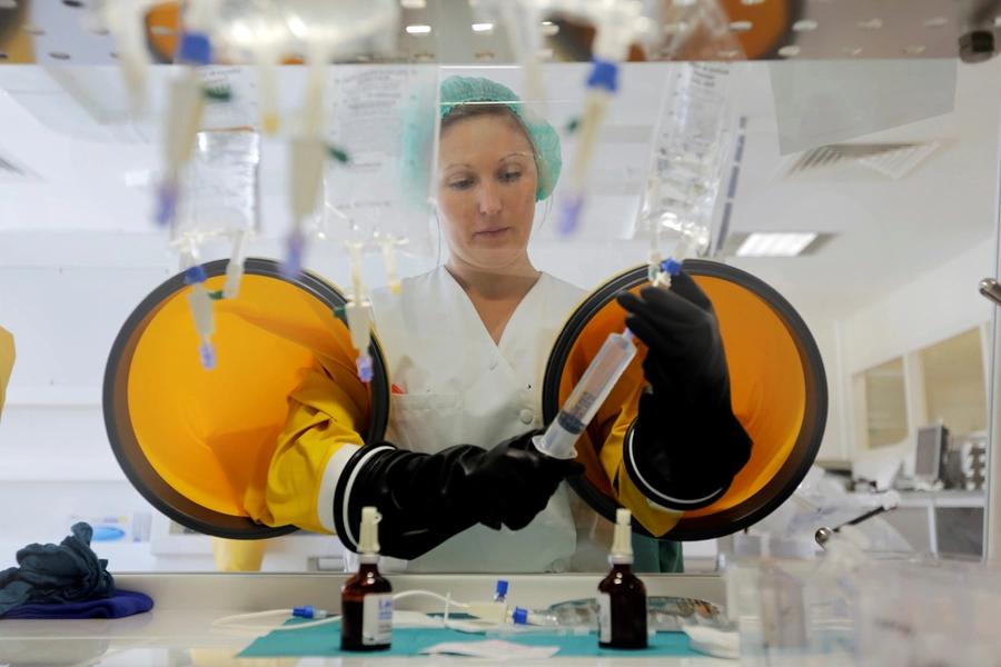 A dispensing chemist prepares drugs for a chemotherapy treatment in a sterile room at Antoine-Lacassagne Cancer Centre in Nice October 18, 2012. Picture taken October 18, 2012.