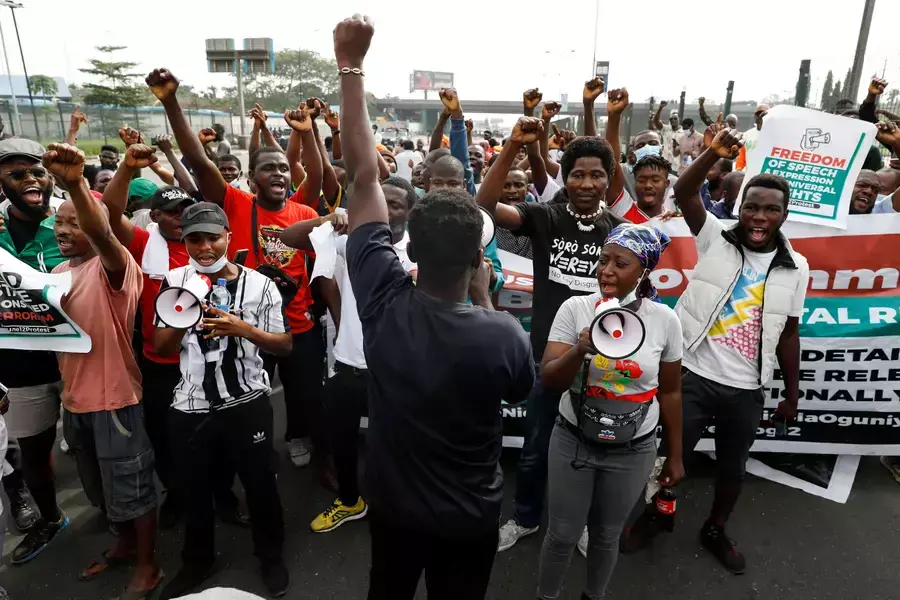 Protesters raise their hands during a June 12 Democracy Day protest at the Gani Fawehinmi Park in Lagos, Nigeria on June 12, 2021.