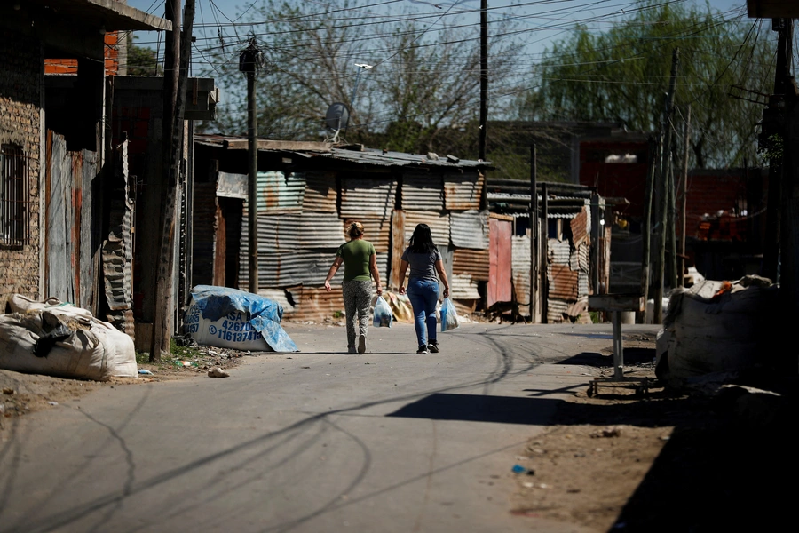 Women carry shopping bags while walking in the working-class neighbourhood Villa Fiorito, in Buenos Aires, Argentina October 9, 2023.