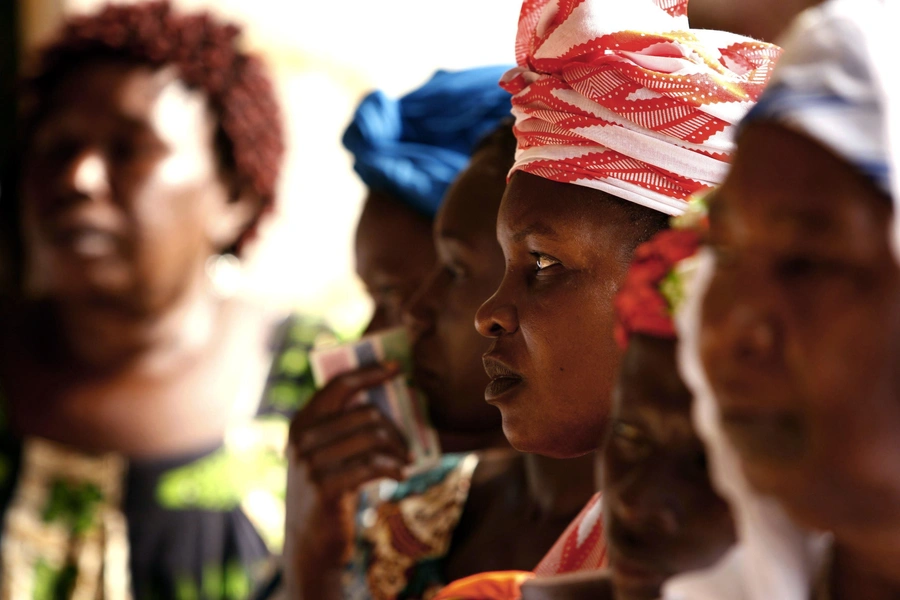 Gambian women wait to enter a polling station in the capital Banjul to vote in the presidential elections September 22, 2006. 