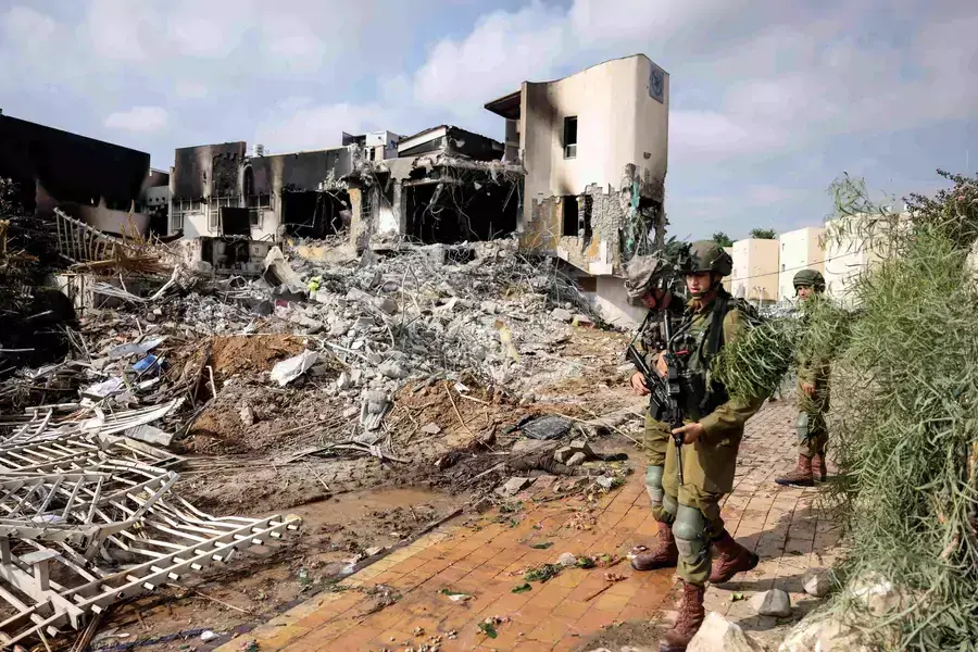 Israeli soldiers patrol outside a police station which was the site of a battle following a mass infiltration by Hamas gunmen from the Gaza Strip, in Sderot, southern Israel, on October 8, 2023.