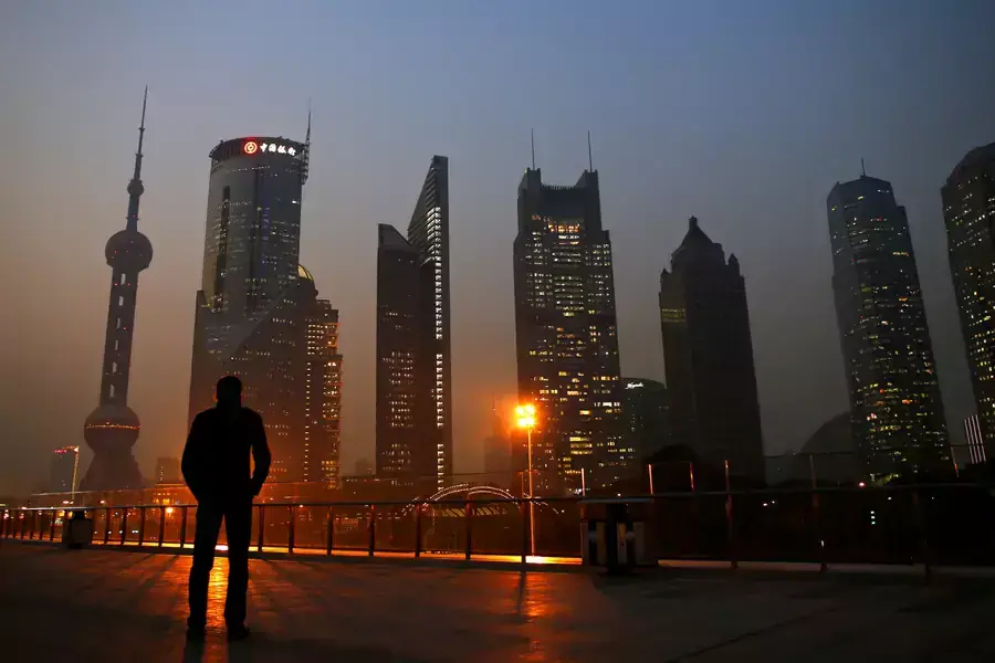 A man looks at the Pudong financial district of Shanghai, China, on November 20, 2013.