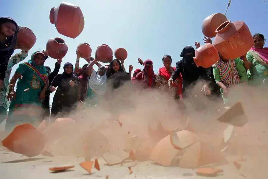 Women throw earthen pitchers onto the ground in protest against the shortage of drinking water outside the municipal corporation office in Ahmedabad, India, May 16, 2019.