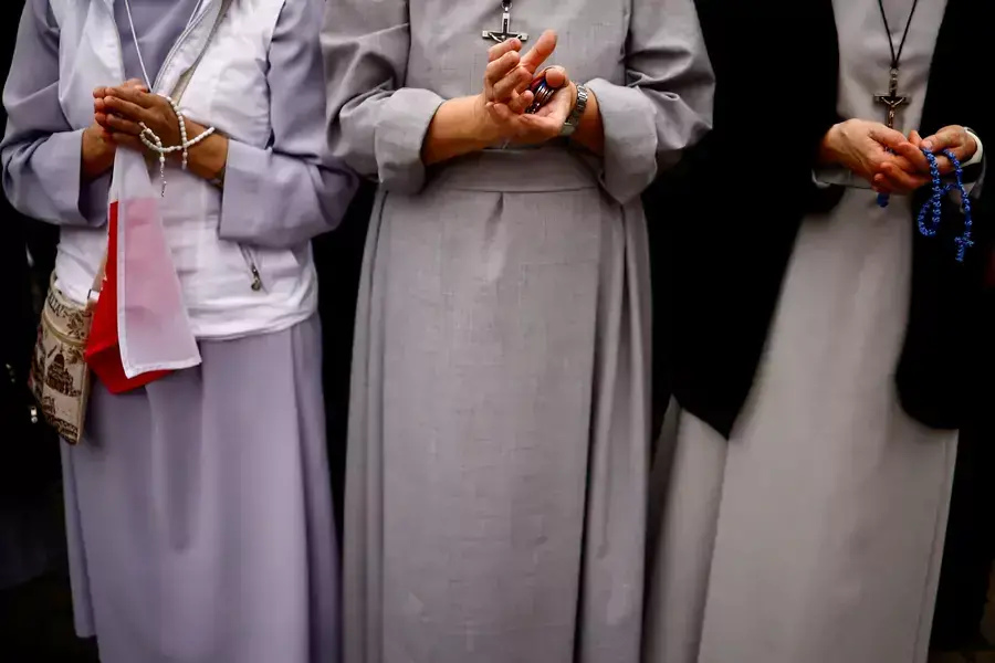 Nuns hold rosaries as Pope Francis celebrates the Angelus prayer from a window for All Saints Day at Saint Peter's Square at the Vatican, November 1, 2023.