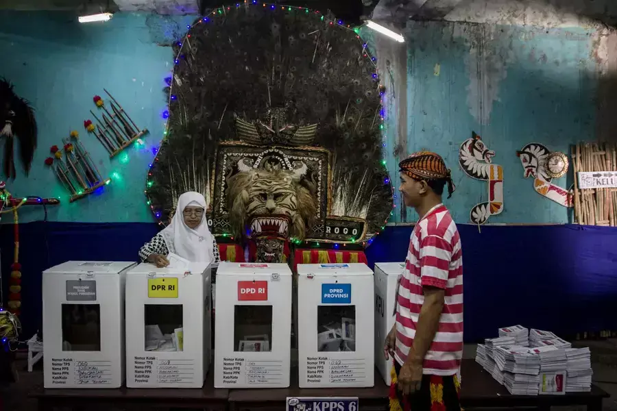 A woman casts her ballot at a polling center in Solo, Central Java province, Indonesia, on April 17, 2019. 