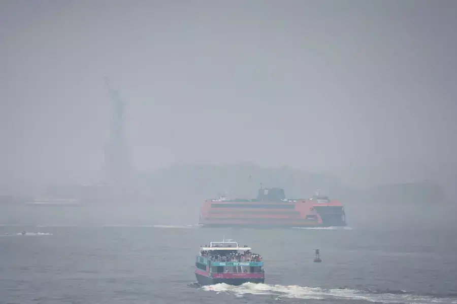 The Statue of Liberty hidden behind smoke from Canadian wildfires on June 30, 2023.