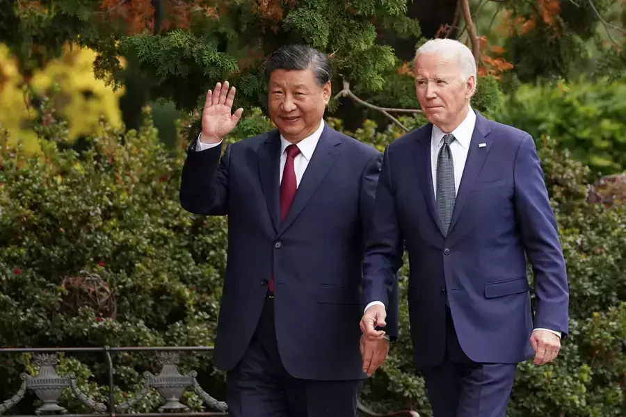 Chinese President Xi Jinping waves as he walks with U.S. President Joe Biden at Filoli estate on the sidelines of the Asia-Pacific Economic Cooperation (APEC) summit, in Woodside, California, November 15, 2023. 