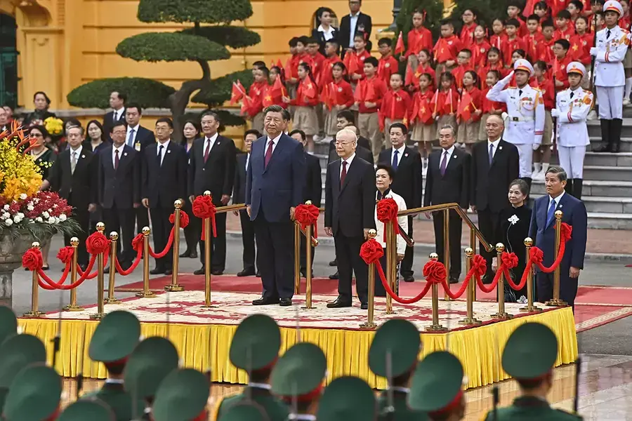China's President Xi Jinping and Vietnam's Communist Party General Secretary Nguyen Phu Trong attend a welcome ceremony at the Presidential Palace in Hanoi on December 12, 2023.