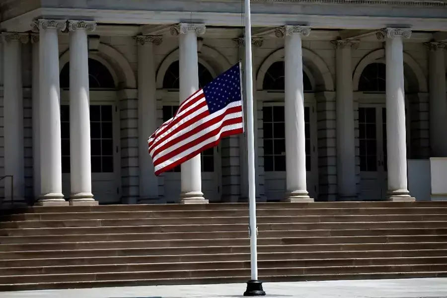 The American flag flies at half-mast outside New York City Hall in Manhattan. 