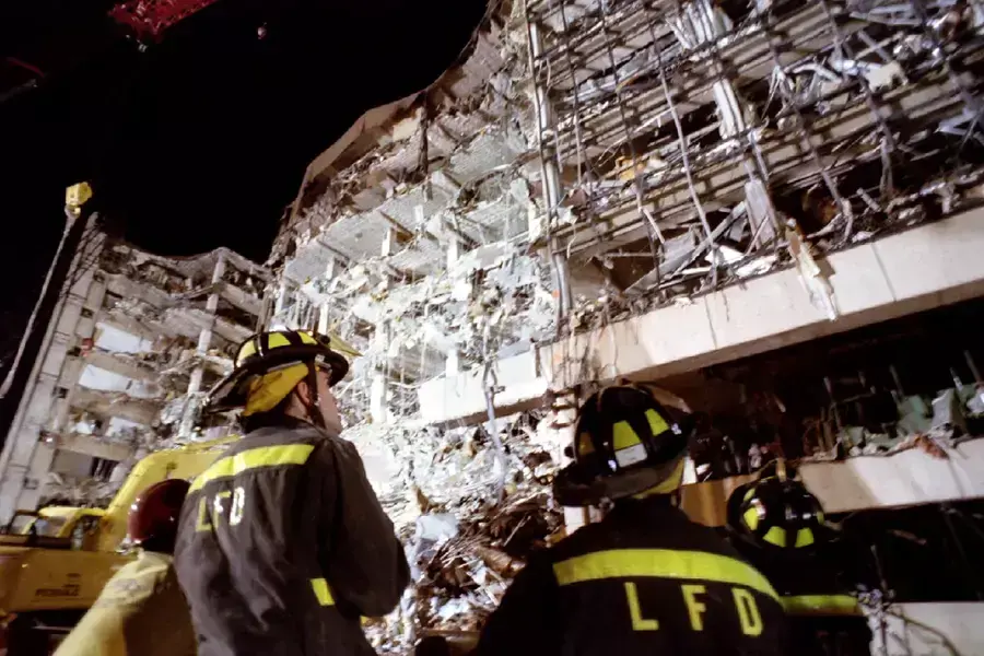 Firefighters examine the wreckage of the Alfred P. Murrah Federal Building in the wake of the 1995 Oklahoma City bombing.