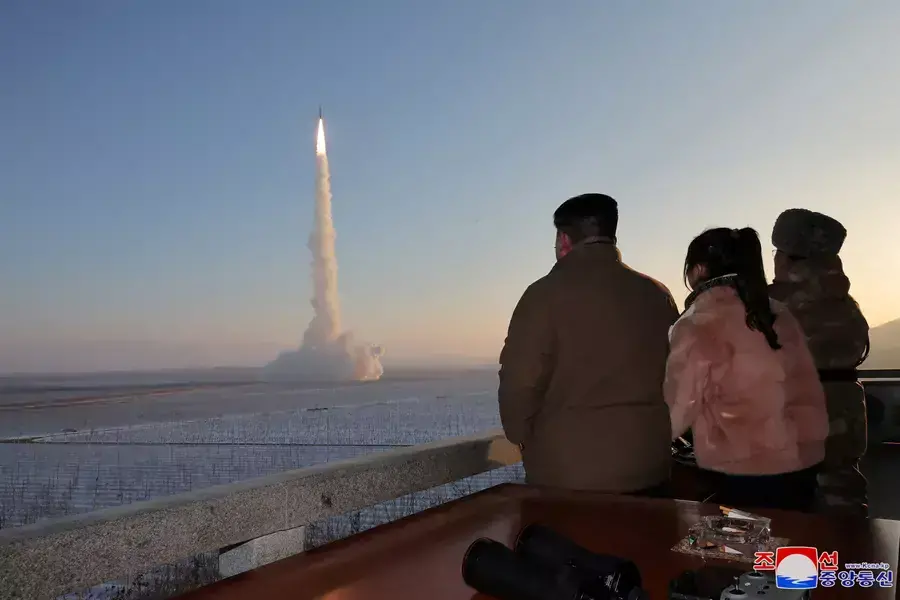 North Korean Leader Kim Jong Un views the launch of a Hwasong-18 intercontinental ballistic missile at an unknown location on December 18, 2023.