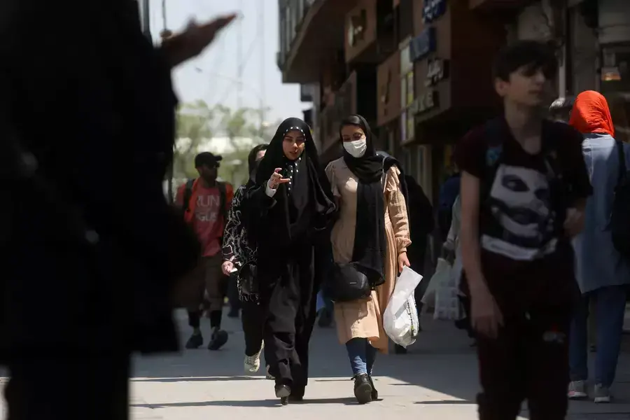 Iranian women walk on a street amid the implementation of the new hijab surveillance in Tehran, Iran, April 15, 2023.